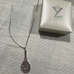 Tennis necklace with pink gem.